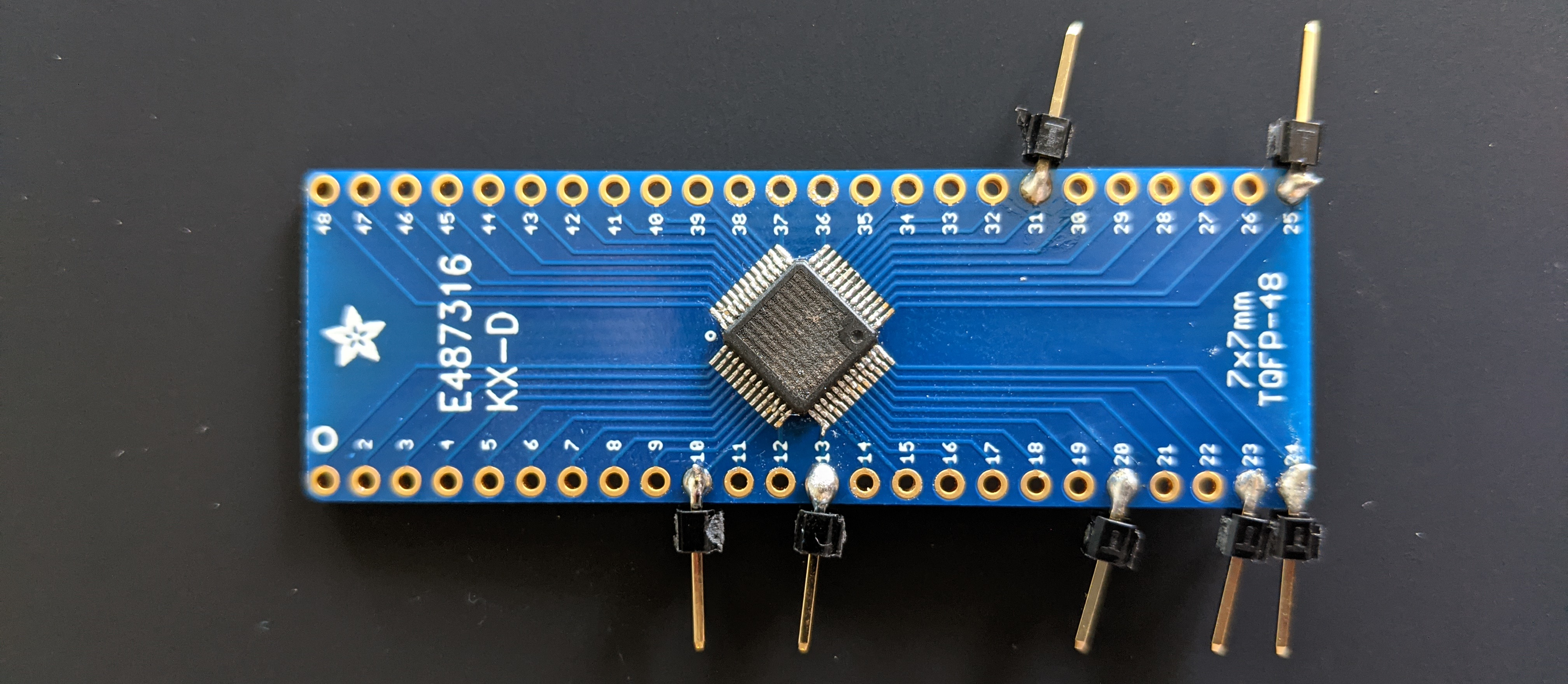 Photo of a QFN48 breakout board with the Rollova’s original STM32 chip soldered on