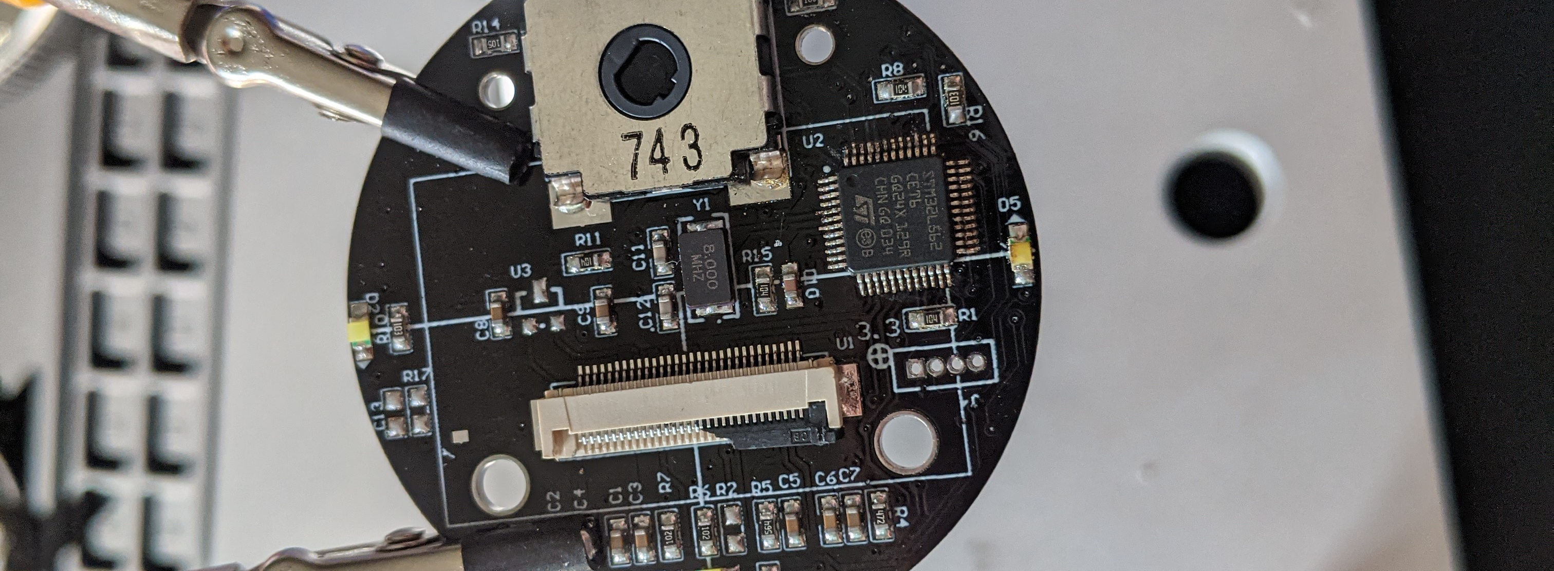 Photo of the board with a new STM32 chip installed, having been soldered and cleaned